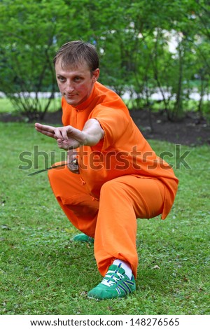 RIGA, LATVIA - JUL 26:  Wushu is one of the most popular martial arts in the world. Sportsman demonstrates his skills in a city park shown on Jul 26, 2013 in Riga