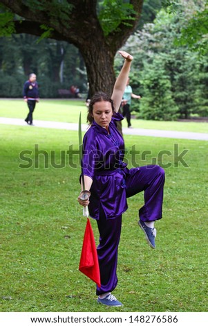 RIGA, LATVIA - JUL 26:  Wushu is one of the most popular martial arts in the world. Woman demonstrates her skills in a city park shown on Jul 26, 2013 in Riga