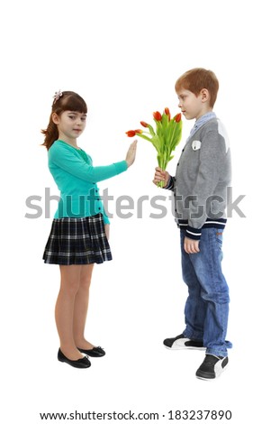 Boy gives flowers to girl. Girl refuses to take flowers. Isolated on white background