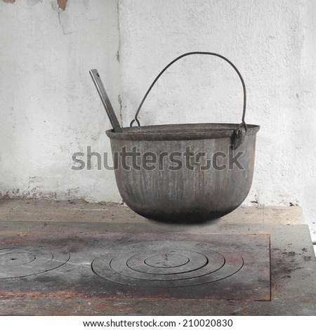 Old dirty boiler on rustic wood-burning stove