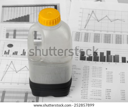 Lack of natural resources - Petroleum crisis - Almost empty can of oil stands over stock market charts