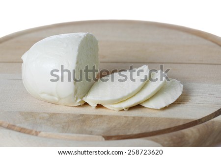 Italian cheese - Mozzarella slices on wooden board