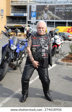 RIGA, LATVIA - APR 26: Biker season opening party participant shows his suit on Apr 26, 2015 in Riga, Latvia. Party is held annually uniting more than 4,000 members