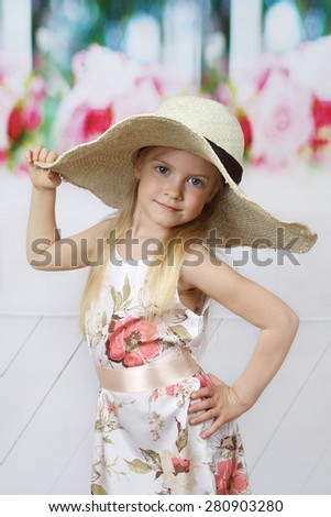 Cute long haired girl in big hat portrait - children beauty and fashion concept