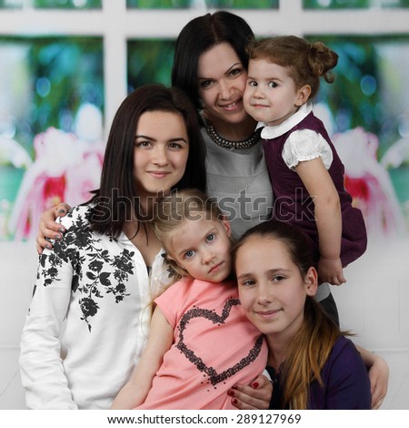 Mother with four all ages daughters portrait - Big family and parenting concept