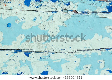 close up shot of old light blue paint texture peeling off wood plank background
