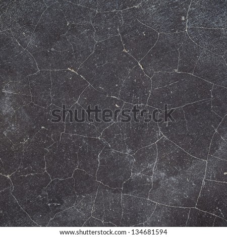 cracked black concrete wall / floor texture background