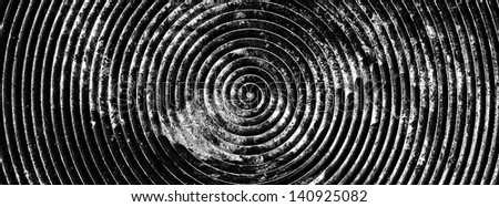 monochrome shot of an old spiral on metal plate texture for banner background
