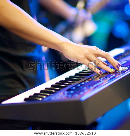 Hands Of Musician Playing Keyboard In Concert With Shallow Depth Of Field, Focus On Right Hand