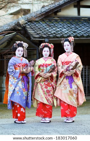 KYOTO - FEB 20, 2014: three young beautiful Japanese women called Maiko wear a traditional dress called Kimono on February 20, 2014 at Gion, Kyoto, Japan.