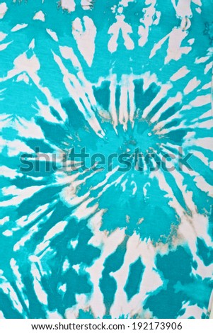 close up shot of turquoise blue and white tie dye fabric texture background