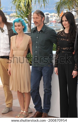 CANNES, FRANCE - MAY 17, 2014: Eva Green, Nanna Oland Fabricius (left) & Mads Mikkelsen at photo call for their movie \