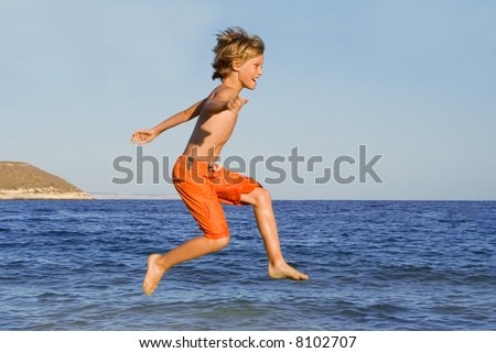 happy boy jumping on vacations(some motion blur on limbs)