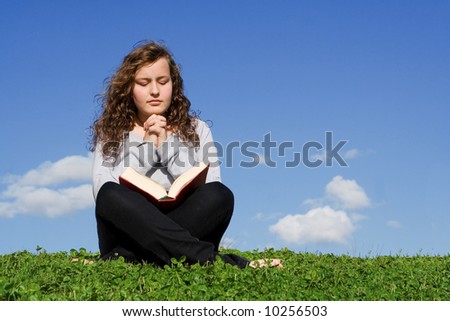 pretty girl reading bible and praying