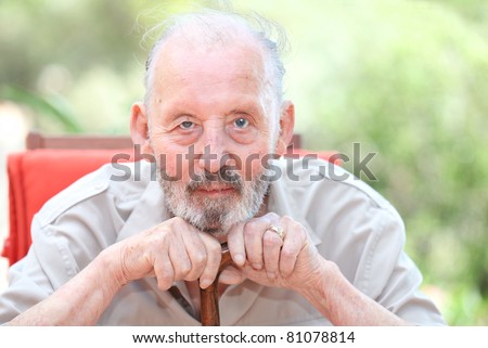 healthy happy old age senior man leaning on walking stick