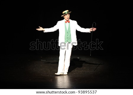 Showman,actor entertainer presenting show or product in the theatre or theater
