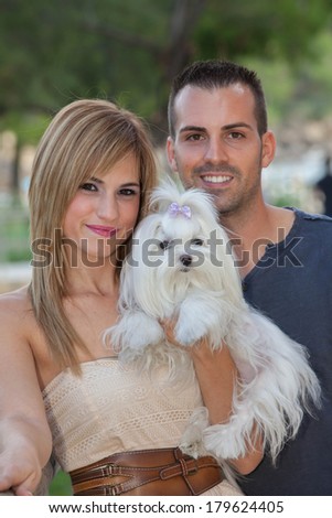 young couple with pet maltese dog