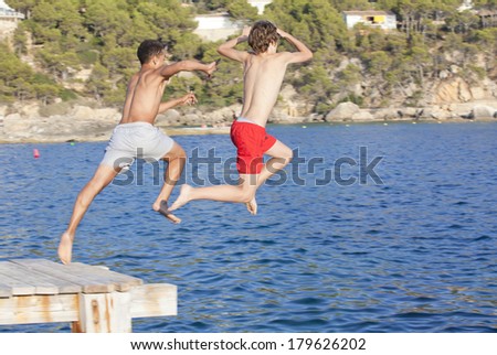 summer camp kids jumping in sea