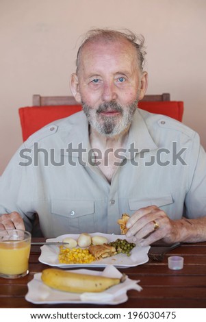 senior eating healthy meal in residential care home