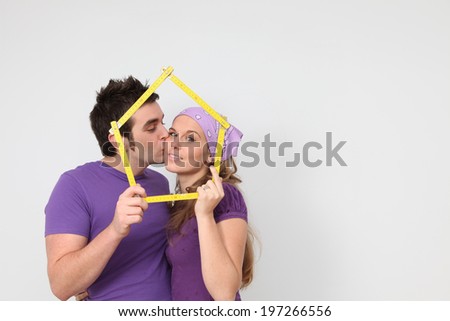 kissing couple getting mortgage loan for new house concept