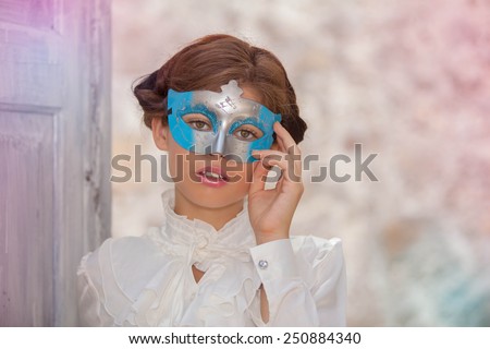 innocent young  woman with face masquerade mask