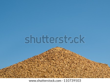 Australian pyramid shape bull ant nest against blue sky background
