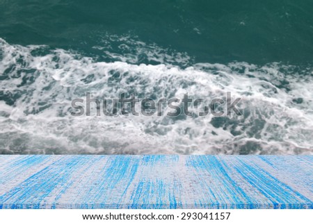 blue wood table top on blur ocean