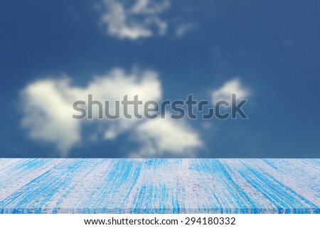 blue wood table top on blur blue  sky background