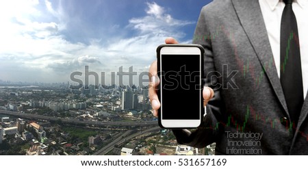 hand hold smart phone with city in background