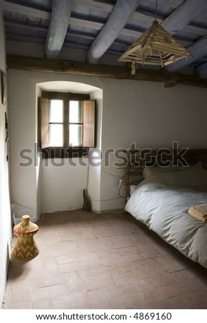 Bedroom in very old house with wooden beams