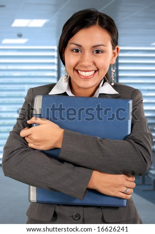 beautiful young employee holding a portable laptop