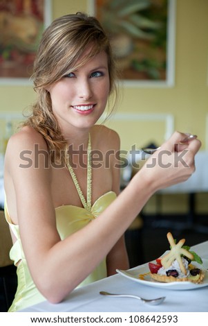 Beautiful Woman Eating Dessert In Fancy Restaurant