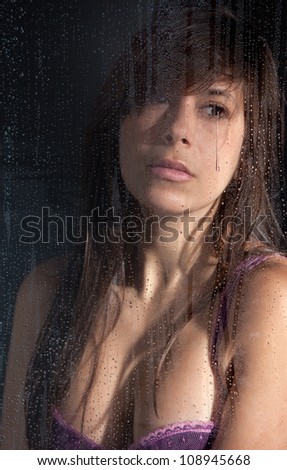 Sad Woman Looking Out Rainy Window