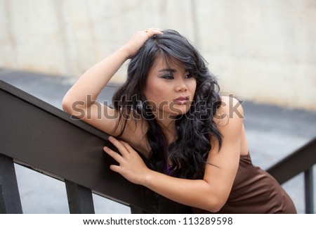 Asian Model Leaning on Stairs