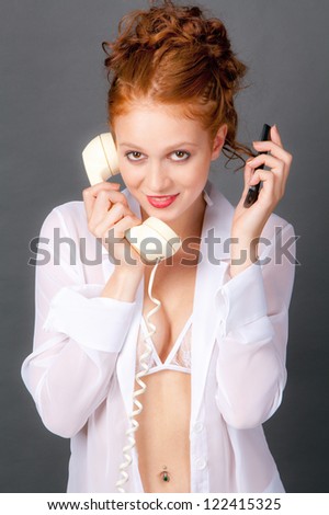 Woman Holding Old Phone in One Hand and Cell Phone in the Other