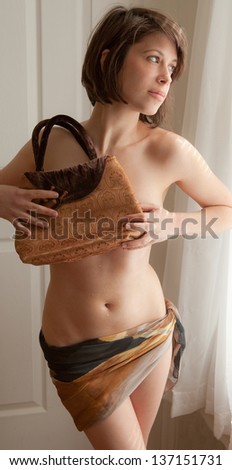 Woman Holding Purse in Front of  Bare Chest