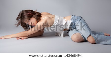 Sexy Model Posing in Ripped Jeans and a Ripped Tank Top