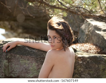 Topless Woman on Mountain Looking Over Shoulder