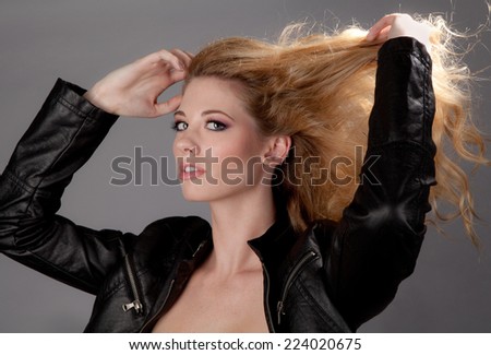 Beautiful Young Woman in Leather Jacket With Blowing Hair