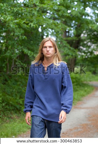 Attractive Young Man Walking Path in Woods