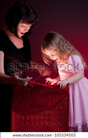 Mother give gift to her little daughter
