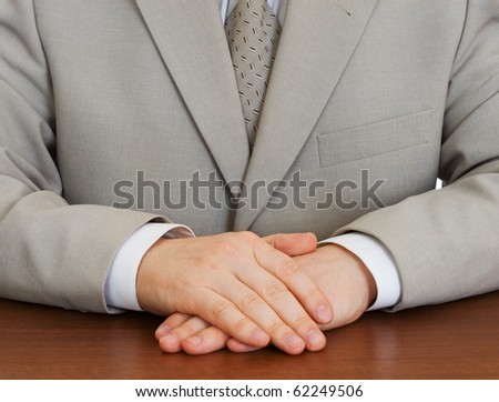 Businessman wearing suit with hands clasped isolated