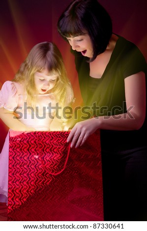 Mother give gift to her little daughter