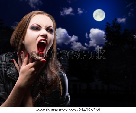 Vampire woman on night background with moon