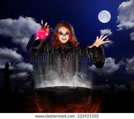 Young witch with red potion and cauldron on night sky background
