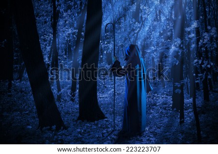 Witch at night in the moonlight forest