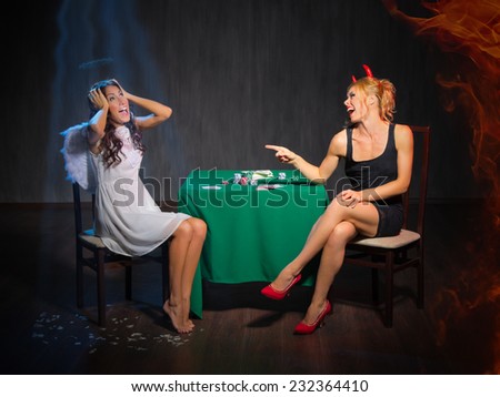 Angel and devil playing cards at room