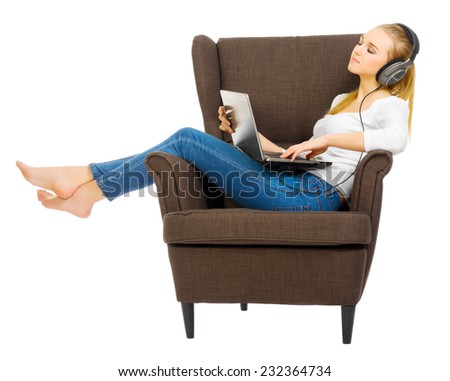 Young girl with headphones listen music on chair isolated