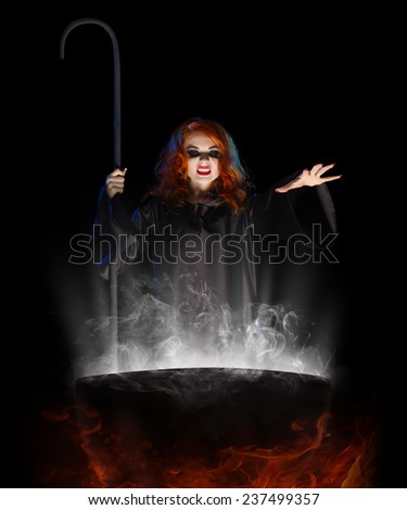 Young witch with cauldron isolated