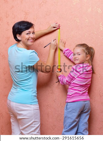 Woman and little girl doing home repair